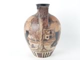 a vase with a painting on it sitting on a table