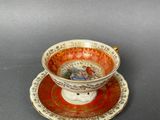 a cup and saucer on a saucer on a table