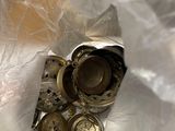 a close up picture of a watch and other items on a plastic bag