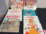 several children ' s books are lined up on a black table