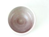 a white bowl with a brown substance in it
