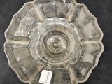 a glass bowl with a lid on a black surface