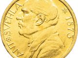 a close up of a gold coin with a man ' s face on it