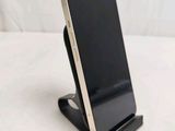 a cell phone that is on a stand on a table