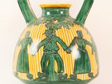 a green and yellow vase with a picture of a man and a woman on it