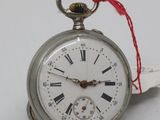 a silver pocket watch with roman numerals on it