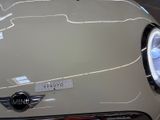 a close up of a white car with a sticker on it ' s hood