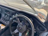 a steering wheel and dashboard of a sports car