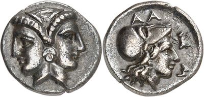 a silver coin with an image of a woman and a man on it