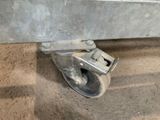 a close up of a metal wheel on the ground