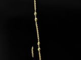 an image of a gold necklace on a black background