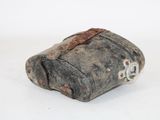 a small piece of stone that is sitting on a white surface