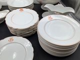 a lot of plates and bowls on the table