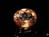 a close up of a yellow diamond on a black surface
