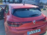 a red car parked next to a black car in a parking lot