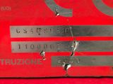 a close up of a metal sign on a red surface