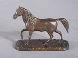 bronze statue of a horse on a base on a white background