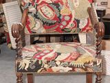 a chair with a floral upholstered seat in a room