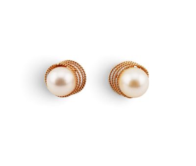 a pair of pearl and gold earrings on a white background