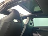 the interior of a car with the sunroof down and the door open