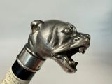 a close up of a metal dog head on a wine bottle stopper
