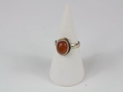 a close up of a ring with a red stone on it