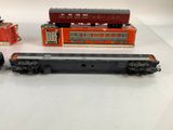 three toy trains sitting on a table next to each other