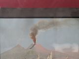 a picture of a painting of a volcano on the water