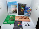 many different colors of eyeshadow on the table