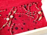 a box with beads and beads in it on a table