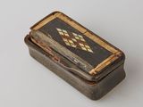 a small box with a design on it on a white surface