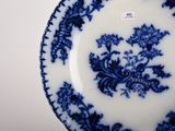 a blue and white plate with a floral design on it