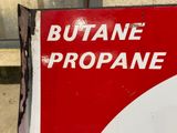 a red and white sign that says butane propane