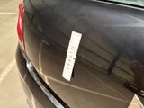 a sticker on the back of a car that is parked in a parking lot
