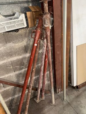 a red fire hydrant sitting in the corner of a room