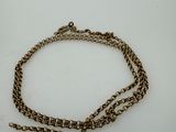 a close up of a chain with a clasp on a white surface