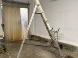 a ladder in the middle of a room that is being remodeled