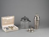 several silver objects are sitting on a table next to each other