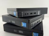 three black boxes stacked on top of each other on a white surface