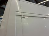 an image of a white refrigerator in a warehouse