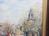 a painting of a man riding a horse on a street