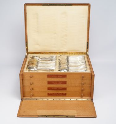 a wooden box with silverware in it on a white surface