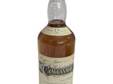 a bottle of whisky with a white label on it