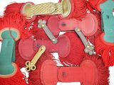 a pile of red and green dog toys on a white surface