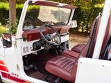 a red and white jeep with a steering wheel