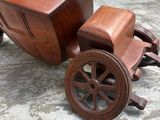 a wooden toy truck with a wooden seat and wheels