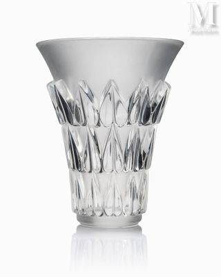 a glass vase that is sitting on a white surface