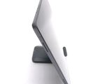 a tablet computer sitting on a stand on a white surface