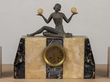 a statue of a woman sitting on top of a clock