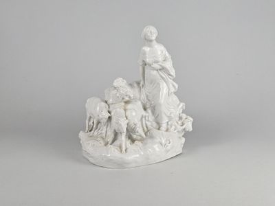 a white statue of a woman with a dog and sheep